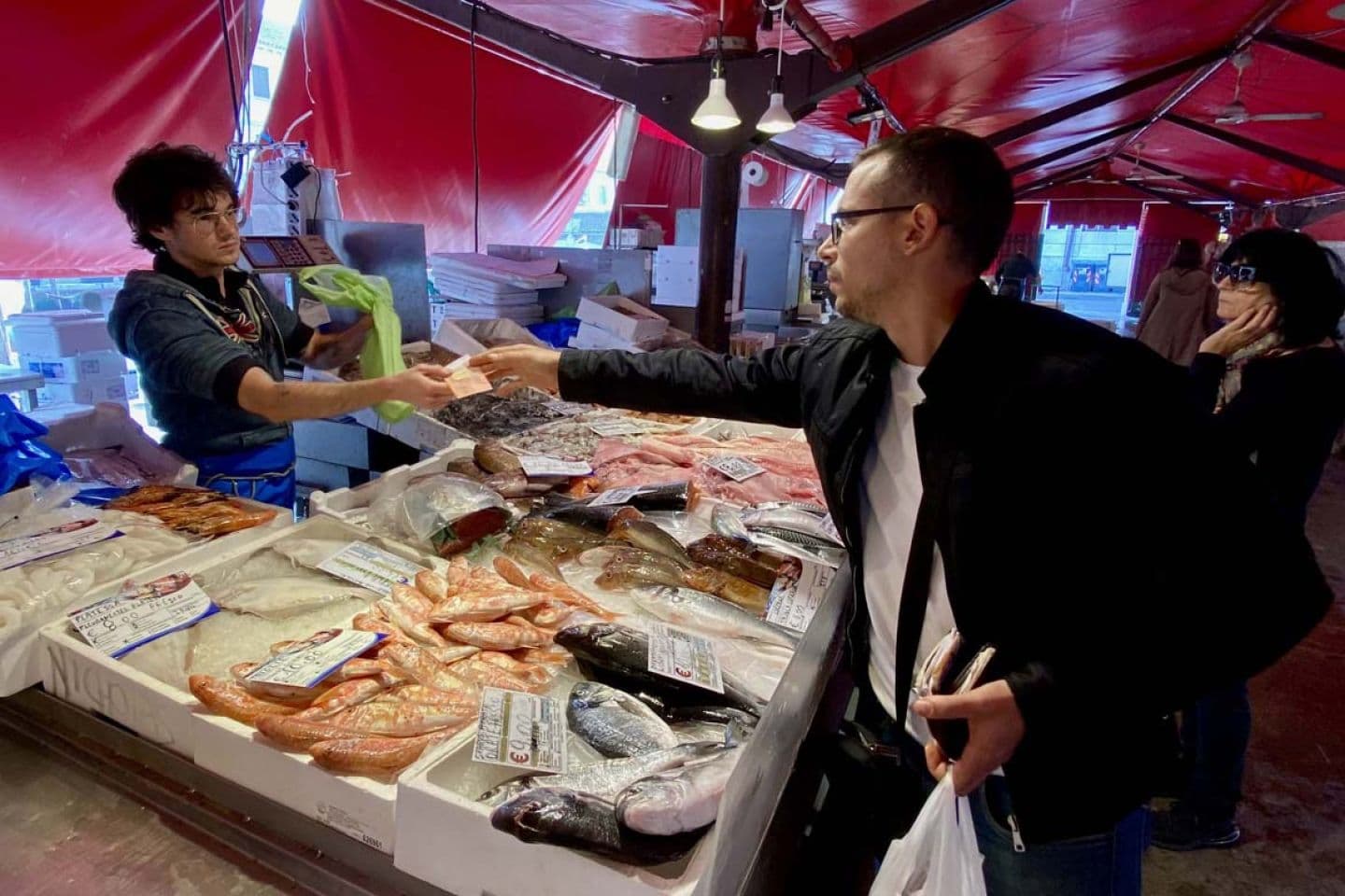 Guest choosing fresh fish at Chioggia market with the chef